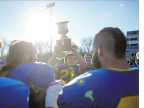 Saskatoon Hilltops running back Logan Fischer raises the The Prairie Football Conference trophy after he and his team defeated the Calgary Colts in the Prairie Football Conference nal at SMF Field on Sunday. Stories on Pages C1, C2.
