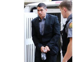 Jonathan Kenneth Dombowsky, accused of first-degree murder in the shooting of Isho Hana in 2004, enters Queen's Bench Courthouse for pre-trial motions in Saskatoon on July 24, 2014.