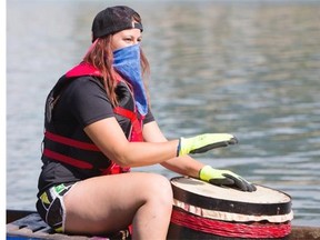 A drummer gets warmed up on her boat prior to racing during the FMG´s Dragon Boat Festival fundraising event at Rotary Park on Saturday, July 25th, 2014.