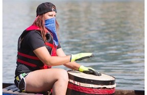 A drummer gets warmed up on her boat prior to racing during the FMG´s Dragon Boat Festival fundraising event at Rotary Park on Saturday, July 25th, 2014.