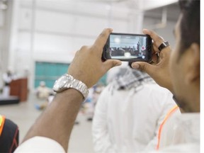 SASKATOON, SASK--JULY 18 2015-A man takes a photo during the Eid festival, which marks the end of Ramadan, the Islamic holy month of fasting, at Prairieland Park on Saturday, July 18th, 2015.LIAM RICHARDS/STAR PHOENIX)