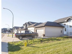 Police tape and a commissionaire stand watch over 1527 Paton Crescent on Tuesday, October 13th, 2015. Saskatoon Police are investigating a sudden death that occurred last night, a 45-year-old female was pronounced deceased at the scene.