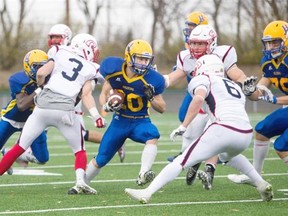 Saskatoon Hilltops running back Adam Machart runs the ball against the Calgary Colts in CJFL action at SMS field on Sunday.