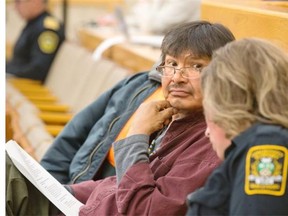 Brandon Nataway seated in city council chambers with a street patrol officer is ready to speak on behalf of the good the officers do, September 28, 2015