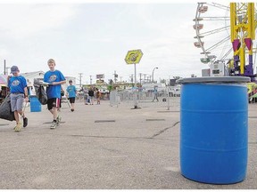 Saskatoon Ex workers and volunteers pick up garbage at the fairgrounds on Aug. 4. Young people are gaining valuable job experience through the partnership with Prairieland Park.