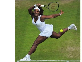 Serena Williams returns the ball to Victoria Azarenka during their women's quarter-finals match at the Wimbledon Championships on Tuesday. Williams won 3-6, 6-2, 6-3.