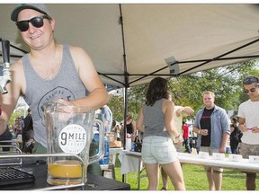 Shawn Moen of 9 Mile Legacy Brewing serves up some red beer — which gets it’s colour from beets — at YXE Beerfest at Rotary Park on Saturday, August 29th, 2015.