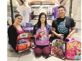 Shopindig.ca staffer Karla Bowman, left, and owners Heather Abbey and Samuel Tipewan show off backpacks that are part of a donation toward a back-to-school supply drive that Abbey has launched.