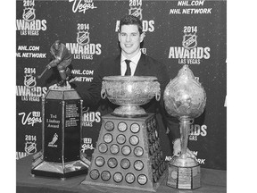 Sidney Crosby of the Pittsburgh Penguins poses with the Ted Lindsay Award for being voted most outstanding player in the league by the players, the Art Ross Trophy for leading the league in scoring points, and the Hart Memorial Trophy which recognizes the most valuable player to his team, at the 2014 NHL Awards night in Las Vegas. The 2015 event is slated for Wednesday also in Las Vegas.
