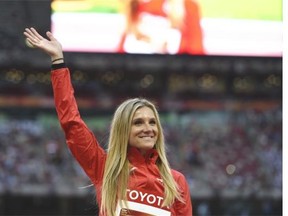 Silver medallist Canada's Brianne Theisen Eaton waves during the victory ceremony for the women's heptathlon athletics event at the 2015 IAAF World Championships at the "Bird's Nest"  National Stadium in Beijing on August 24, 2015.  AFP PHOTO / GREG BAKERGREG BAKER/AFP/Getty Images