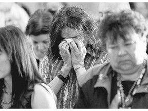 A Sixties Scoop adoptee weeps at a gathering before a provincial apology from the Manitoba government.