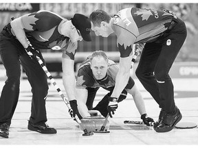 Skip Brad Jacobs releases his rock to sweepers Ryan Harnden, left, and E.J. Harnden. Many leading curlers are calling for a ban on a new broomhead featuring 'directional fabric,' allowing sweepers to control the rock's direction.