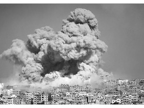 Smoke and fire erupt from the explosion of an Israeli strike rise over Gaza City last July. A United Nations report on the conflict that killed 2,200 Palestinians and 73 on the Israeli side was released Monday.