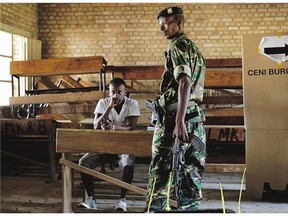 A soldier gets ready to cast his vote in the presidential elections in Bujumbura, Burundi on Tuesday. A low turnout was experienced in several polling stations in Burundi's capital at the start of voting following a night of explosions and gunfire.