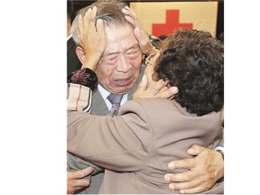 South Korean Min Ho-shik, 84, centre, hugs his North Korean family member Min Un Sik, right, during the Separated Family Reunion Meeting Tuesday in North Korea.