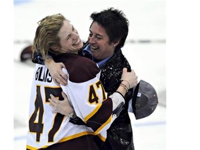 Minnesota-Duluth's Emmanuelle Blais celebrates with head coach Shannon Miller after defeating Cornell 3-2 after the third overtime at the NCAA Women's Frozen Four championship hockey game Sunday, March 21, 2010, at Ridder Arena in Minneapolis.