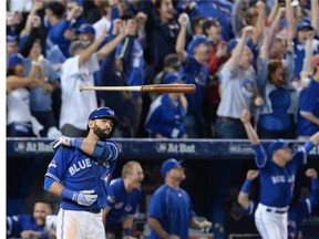 Toronto Blue Jays' Jose Bautista tosses his bat after hitting a three-run home run during seventh inning game five American League Division Series baseball action against the Texas Rangers in Toronto on Wednesday, October 14, 2015. THE CANADIAN PRESS/Chris Young