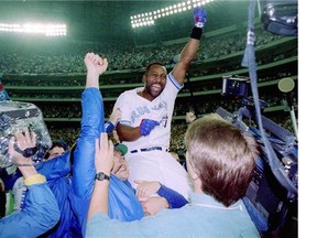 Joe Carter is held up after hitting a three-run homer in the bottom of the ninth to win the World Series against the Philadelphia Phillies at the SkyDome.