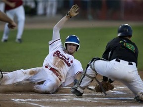 Trevor Fonseca of Team B.C. slides in safe at home in front of Team Saskatchewan catcher Bryce Rueve to help B.C. take a 4-1 first-inning lead in the Baseball Canada Cup championship final at Cairns Field Monday, August 10, 2015. (Greg Pender/The StarPhoenix)