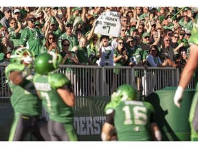 Fans cheer after Saskatchewan Roughriders slotback Weston Dressler scores a touchdown against the Ottawa Redblacks during the forth quarter CFL football action at Mosaic Stadium on Sunday, September 21, 2014 in Regina. THE CANADIAN PRESS/Liam Richards