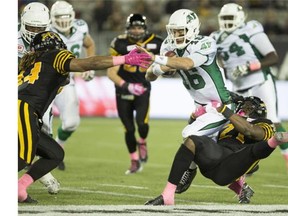 Saskatchewan Roughriders quarterback Brett Smith (16) is sacked by Hamilton Tiger-Cats defensive lineman Everett Ellefsen (71) during the second half of CFL football action in Hamilton on Friday, October 9, 2015. THE CANADIAN PRESS/Peter Power