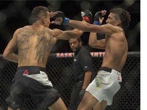 Max Holloway (left) beat Charles Oliveira in the main event of UFC Fight Night in Saskatoon on Aug. 23, 2015