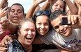 Ultimate Fighting Championship bantamweight champion Ronda Rousey takes photos with fans during a UFC 190 open training session at Pepe Beach on July 29, 2015 in Rio de Janeiro, Brazil. (Photo by Buda Mendes/Zuffa LLC/Zuffa LLC via Getty Images)