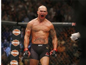 Rory MacDonald lies on the mat after he was defeated by Robbie Lawler in their welterweight title fmixed martial arts bout at UFC 189 on Saturday, July 11, 2015, in Las Vegas. (AP Photo/John Locher)