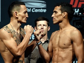 SASKATOON, SK - AUGUST 22: (L-R) Opponents Max Holloway of the United States and Charles Oliveira of Brazil face off during the UFC weigh-in at the SaskTel Centre on August 22, 2015 in Saskatoon, Saskatchewan, Canada. (Photo by Jeff Bottari/Zuffa LLC/Zuffa LLC via Getty Images)