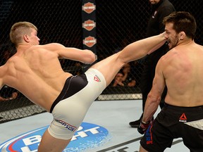 Stephen Thompson kicks Jake Ellenberger in their welterweight bout during the Ultimate Fighter Finale inside MGM Grand Garden Arena on July 12, 2015 in Las Vegas, Nevada. (Photo by Brandon Magnus/Zuffa LLC/Zuffa LLC via Getty Images)