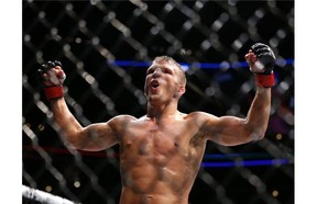 TJ Dillashaw celebrates after defeating Renan Barao during their bantamweight mixed martial arts title bout during UFC Chicago on Saturday, July 25, 2015, in Chicago. Dillashaw won in the fourth round.(AP Photo/Jeff Haynes)  TJ Dillashaw