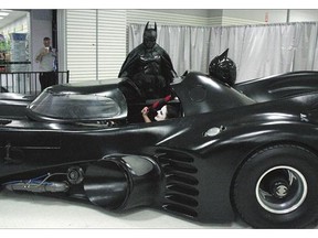 Stephen Lawrence, dressed as Batman, appears with his replica Batmobile during a charity appearance at a mall in Kingston, Ont., on Sunday.