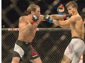 Sam Stout (L) lands a punch on Frankie Perez during a lightweight bout of UFC Fight Night at SaskTel Centre on August 23, 2015.