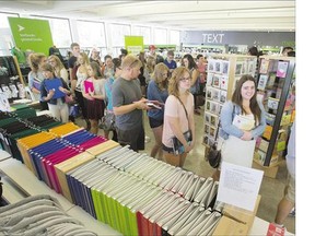 Students of the University of Saskatchewan line up to buy school supplies in the university bookstore on Monday. The fall semester kicks off on Thursday.