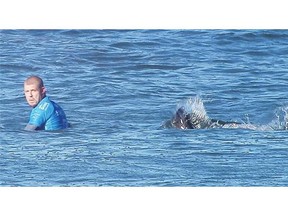 Surfer Mick Fanning fought off an attacking shark in South Africa on Sunday by punching it in the back.