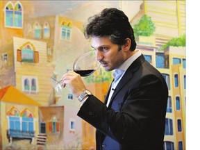 : Syrian businessman Sandro Saade tastes Bargylus red wine at his office in Beirut, Lebanon. It's too dangerous for Saade to travel to his vineyards at home.