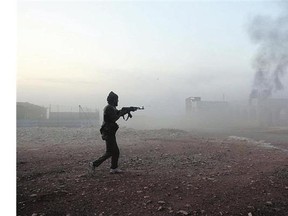 A Syrian opposition fighter fires Saturday in the Mount Azzan area, during reported fighting against Syrian government forces.
