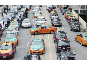Taxi drivers protest Uber in Toronto last month. The ride-sharing service remains deeply controversial across Canada, but the city is taking steps to regulate it.