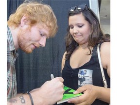 Teagan Williams meets music supterstar Ed Sheeran at SaskTel Centre before Sheeran’s concert Tuesday night in Saskatoon. Sheeran gave Williams a hug, signed a CD and took a selfie with Williams’ cellphone. Williams won concert tickets from the radio station C95 after telling her story of her brother passing away and how the pair loved Sheeran’s music.  (GORD WALDNER/The StarPhoenix)