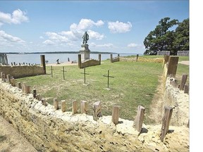 A team of archeologists and historians erect crosses to mark where the four sets of human remains were buried for more than 400 years near the altar of what was America's first Protestant church in Jamestown, Va.