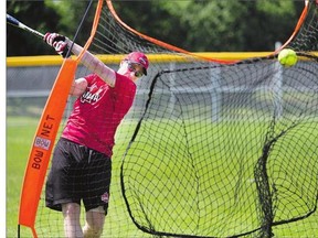 Team Canada's Derek Mayson takes a swing during the squad's first Saskatoon practice on Tuesday. The world men's softball championship begins Friday in Saskatoon, and teams are staging workouts each morning at Glenn Reeve fields.