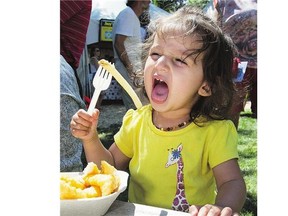 Then-19-month-old Lula Bains goes for a fry from her fish and chips from Joey's Only Seafood Restaurant at last summer's Taste of Saskatchewan.