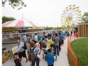 There were lots of smiling faces as the rides and attractions in PotashCorp Playland at Kinsmen Park officially opened Wednesday. Fujian Liu pulls daughter Terrylyn Liu on the zip line.