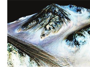 In this handout provided by NASA, dark, narrow streaks on the slopes of Hale Crater are inferred to be formed by the flow of water on the surface of present-day Mars. The streaks represent thin layers of wet soil, not surface streams, say scientists.