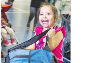 Three year old Tori-Lynn Quewezance was thrilled with her new backpack she received at the White Buffalo Youth Lodge Thursday. The giveaway was part of a carnival in the lodge parking lot. See story on Page A3.