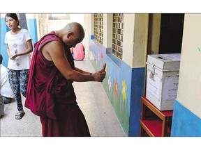 A Tibetan monk-in-exile takes a photograph on his mobile phone of a ballot box during elections to vote for a new Tibetan government-in-exile in New Delhi on Sunday.