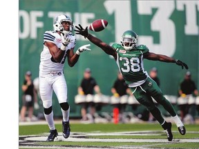 Toronto Argonauts wide receiver Tori Gurley, left, makes a reception while Saskatchewan Roughriders defensive back Tristan Jackson's attempt to block the pass falls just short during Sunday's game at Mosaic Stadium.