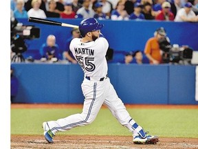 Toronto Blue Jays catcher Russell Martin hits a three run home run against the New York Yankees during seventh inning AL baseball action in Toronto on Wednesday.