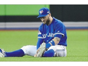 Toronto Blue Jays centre-fielder Kevin Pillar sits in the outfield after making a catch during his team's 14-2 loss Tuesday. The Jays need to win Wednesday to keep their playoff hopes alive.