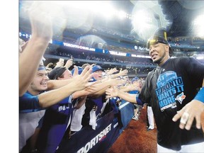 Toronto Blue Jays' Edwin Encarnacion, celebrating with fans after the Jays win in the ALDS against the Texas Rangers Wednesday, is batting .333 with three RBIs in his first post-season appearance.